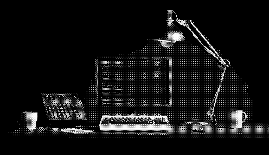 Creative workspace with desk lamp, computer, and design tools